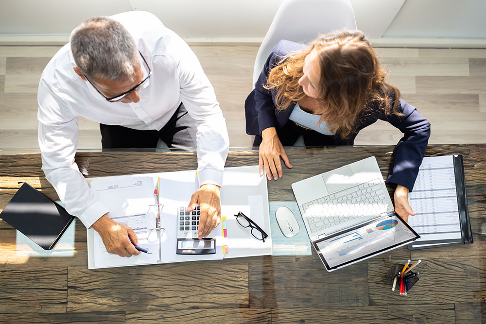 Accountants Using Laptop in Office | Maven Group Investment Strategies