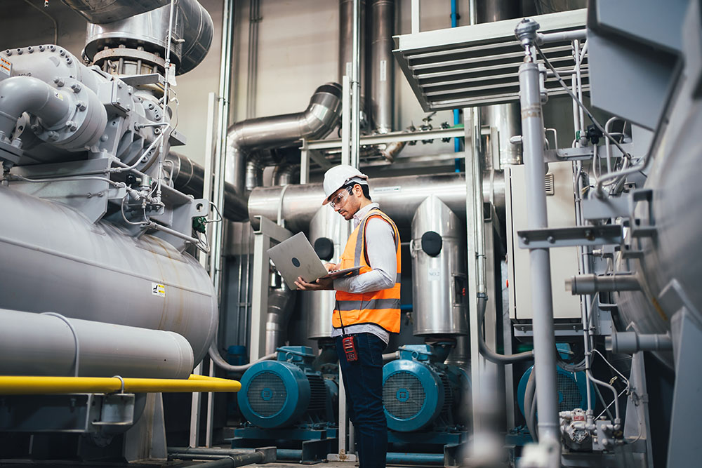 Professional Worker of Modern Factory Using Laptop | Maven Group Investment Strategies